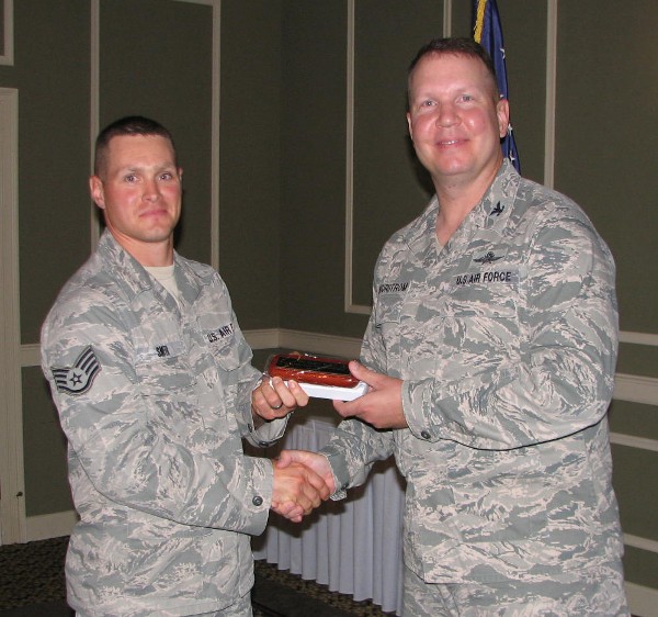 In June, Staff Sgt. Cameron Smith, USAF (l), lead Young AFCEAN, receives the Meritorious Service Award from Col. Bjurstrom in recognition of his efforts in support of the Young AFCEAN program.